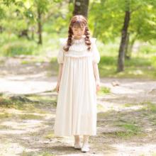 model wearing an off white dress