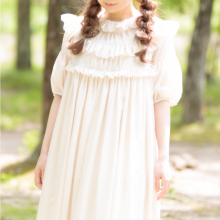 model wearing an off white dress